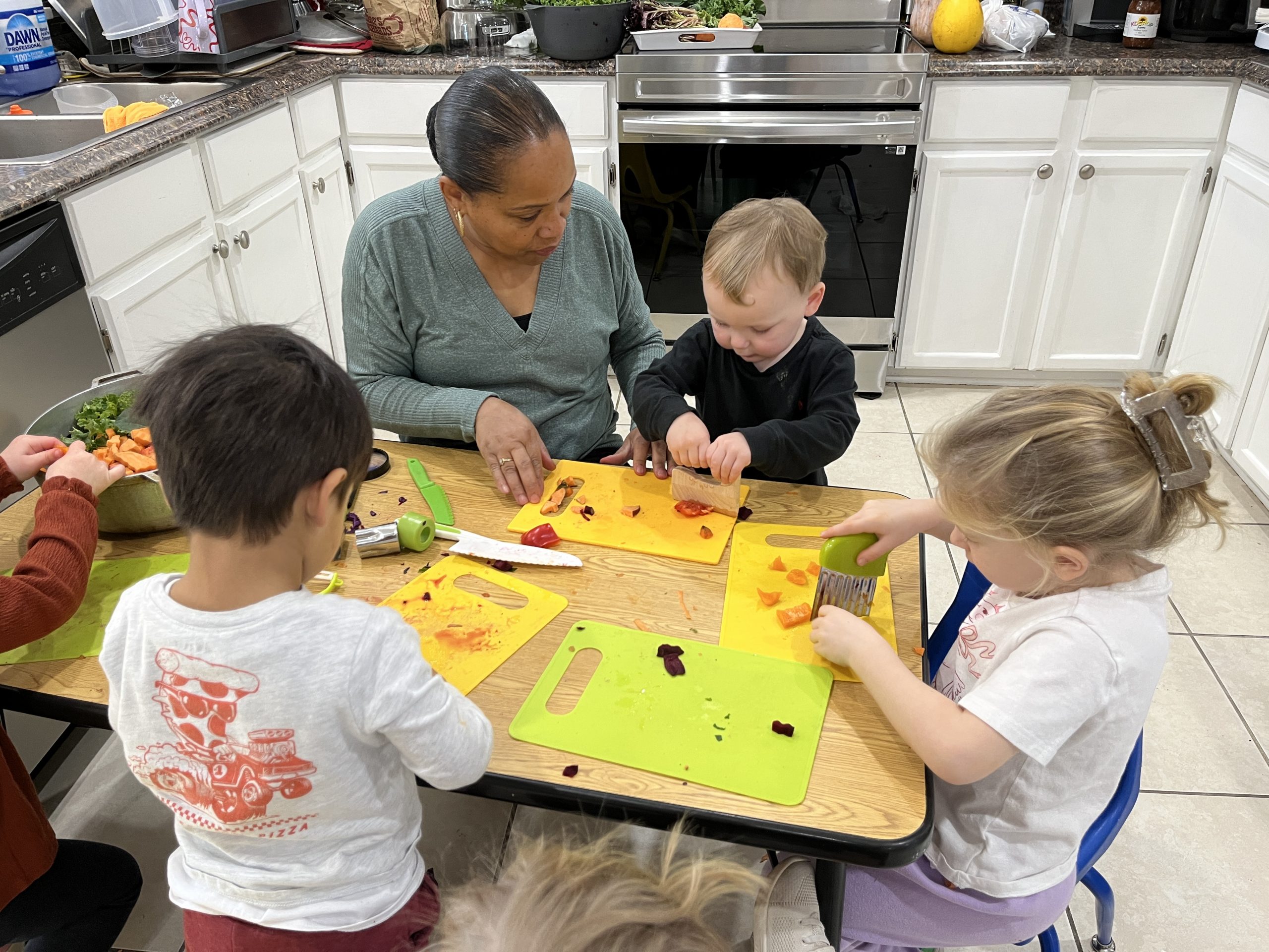 Women with children cutting apples