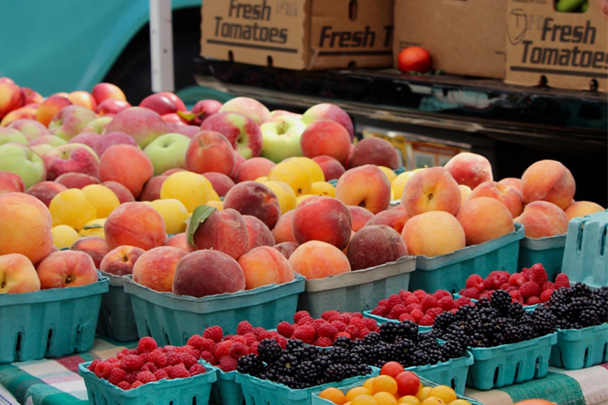 peaches in containers at a store.