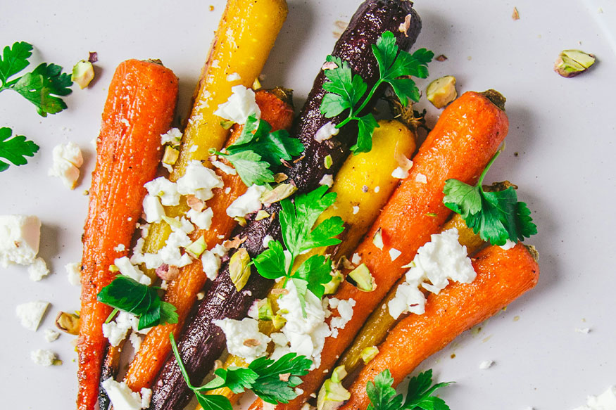 several varieties of carrots with parsley and feta cheese.