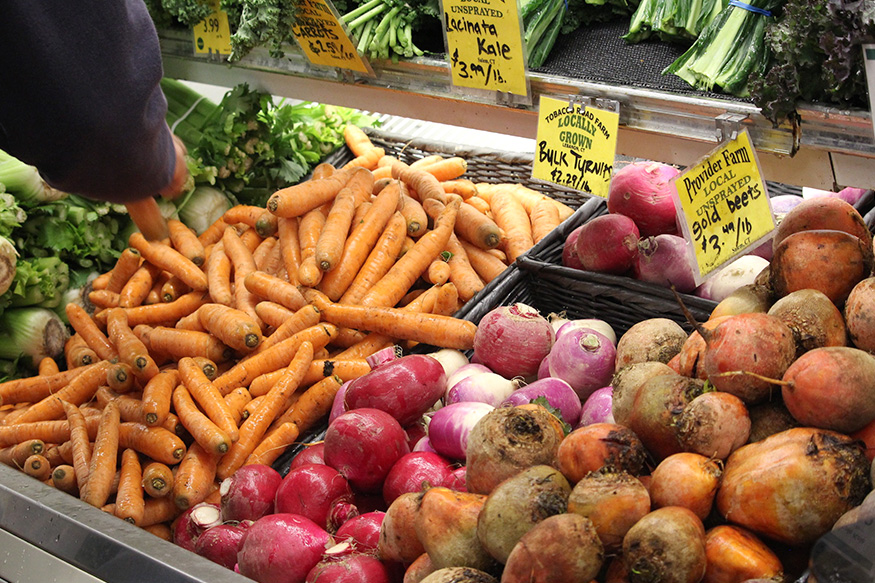 carrots and radishes in a grocery store.