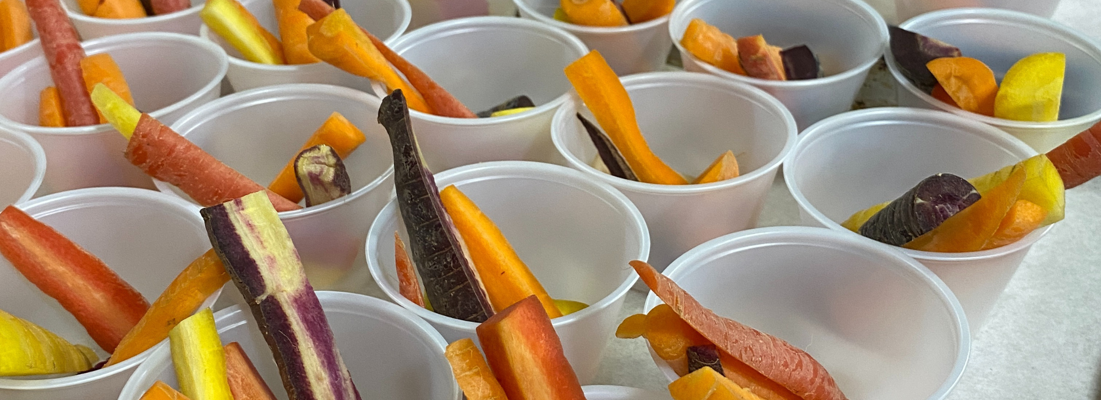 Snack cups with slices of colorful carrots.